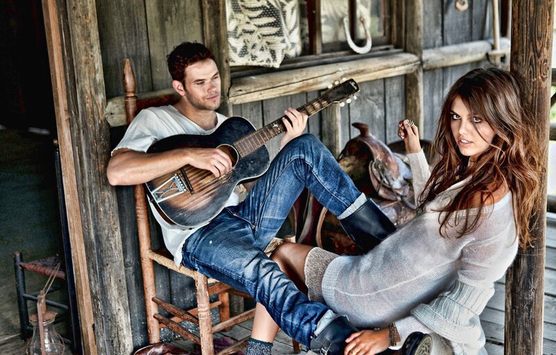 Couple with guitar in rustic setting