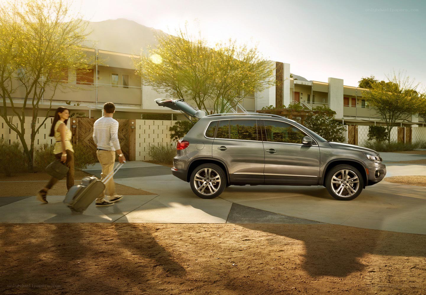Couple with luggage near SUV
