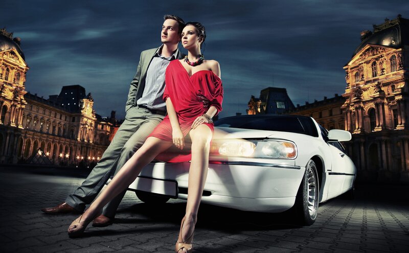Couple with luxury car at night