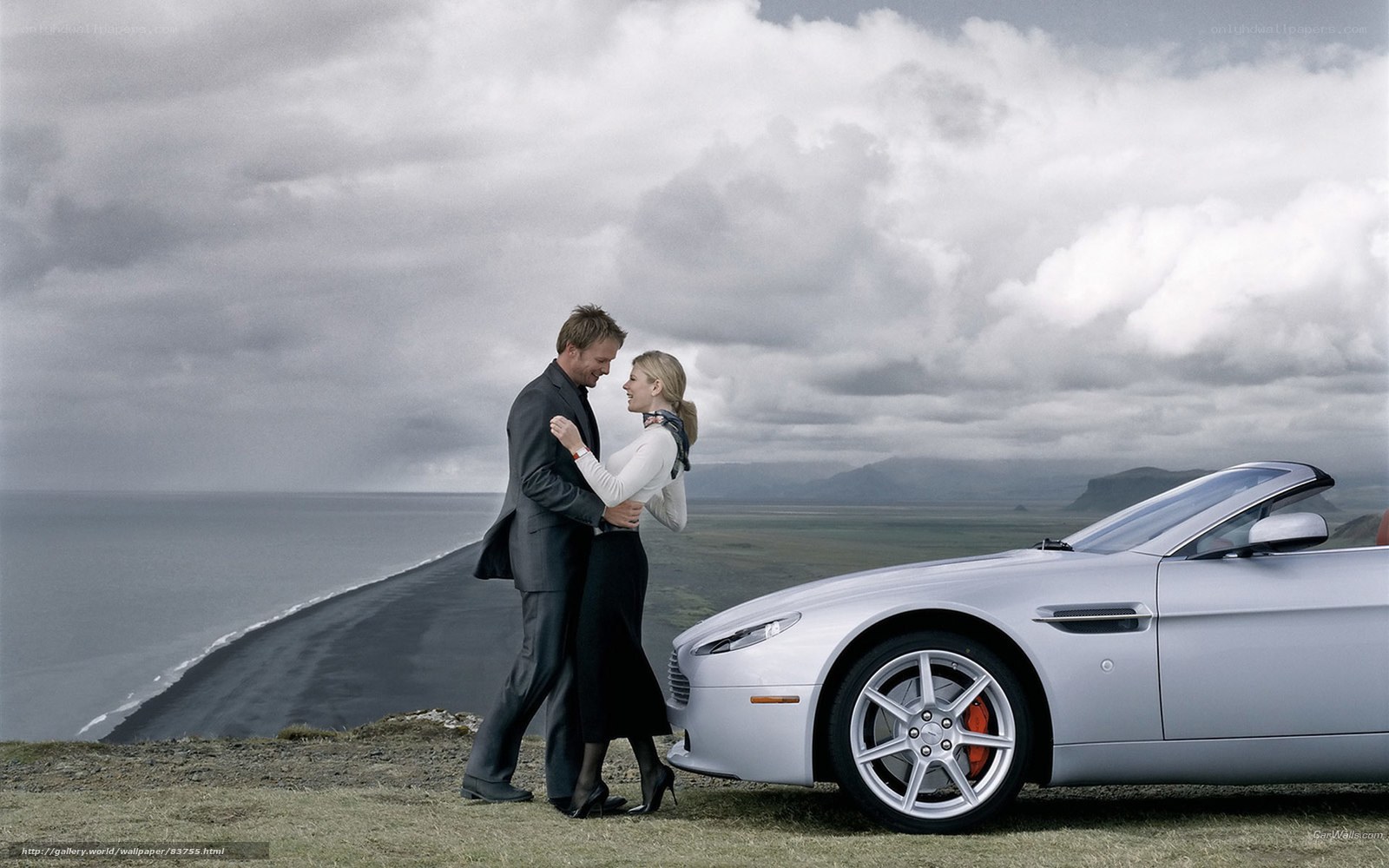 Couple with luxury car on cliff