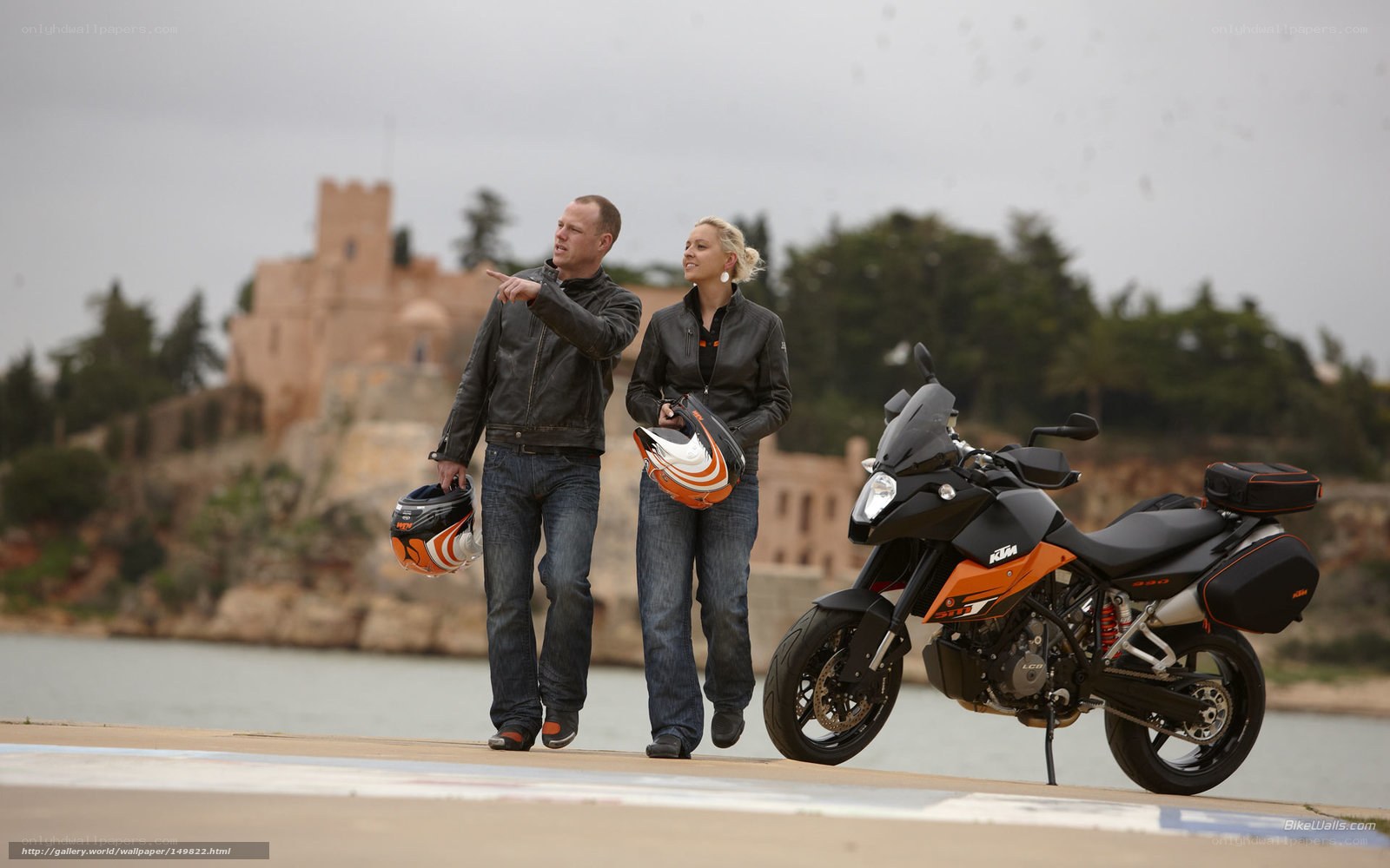 Couple with motorcycle by castle