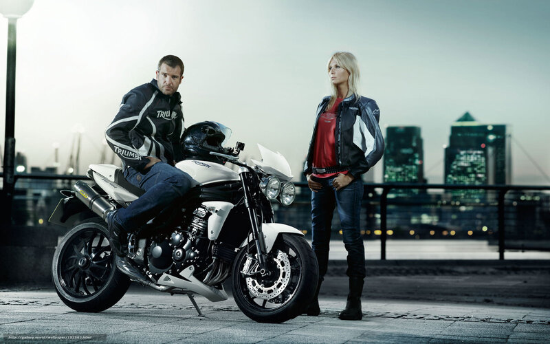 Couple with motorcycle in city