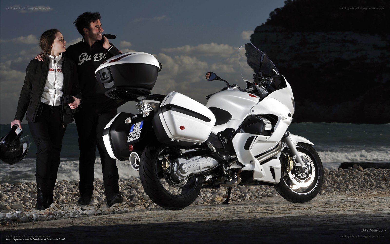 Couple with motorcycle on beach