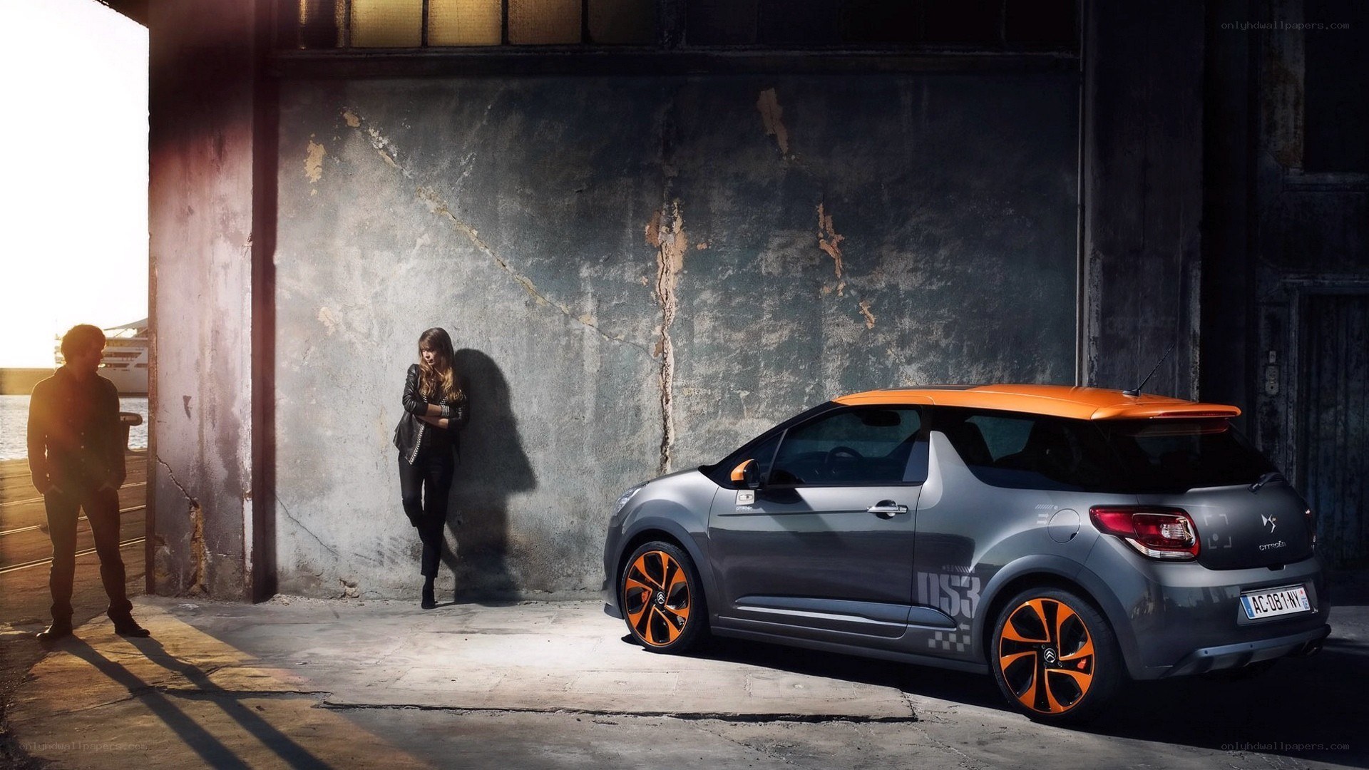 Couple with orange-roofed car