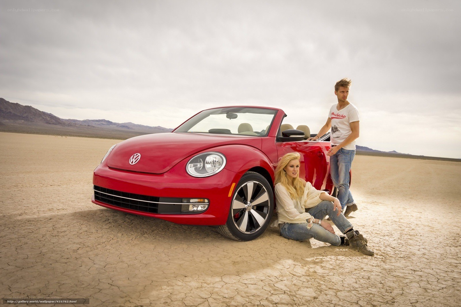Couple with red convertible car
