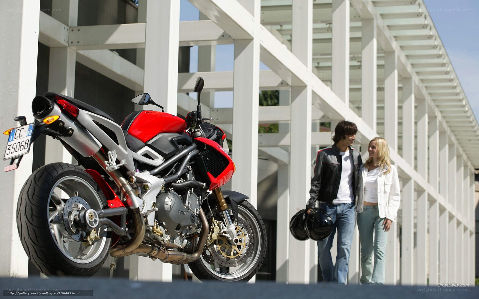 Couple with red motorcycle