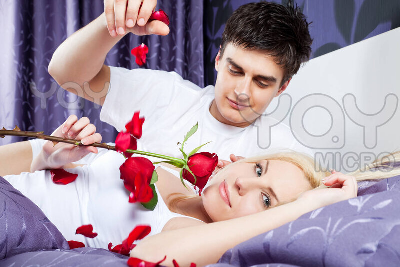 Couple with Roses in Bed