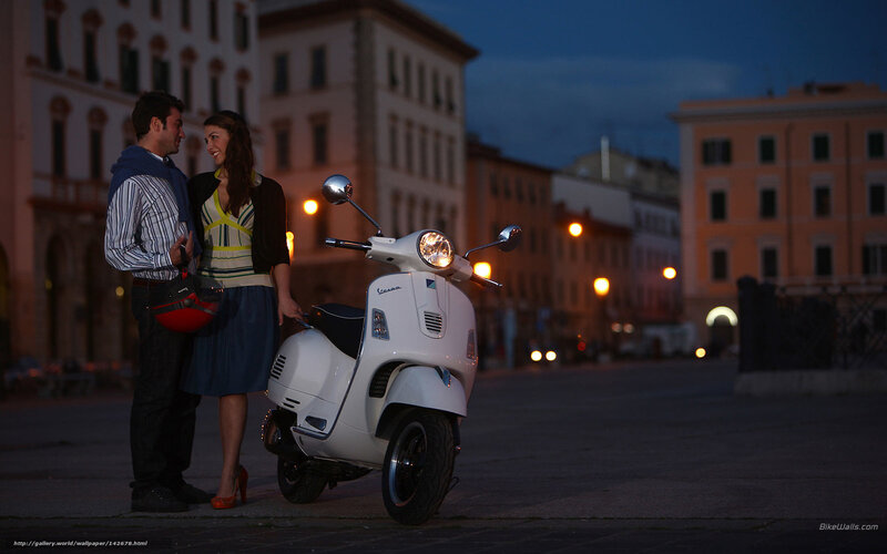 Couple with scooter at dusk