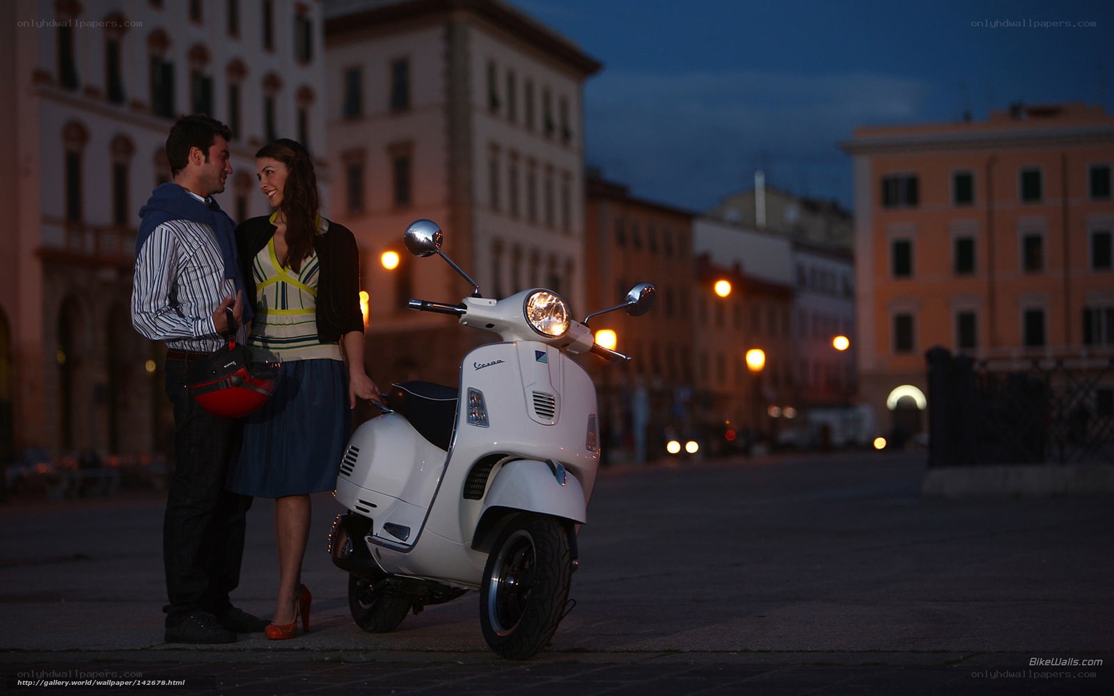 Couple with scooter at dusk