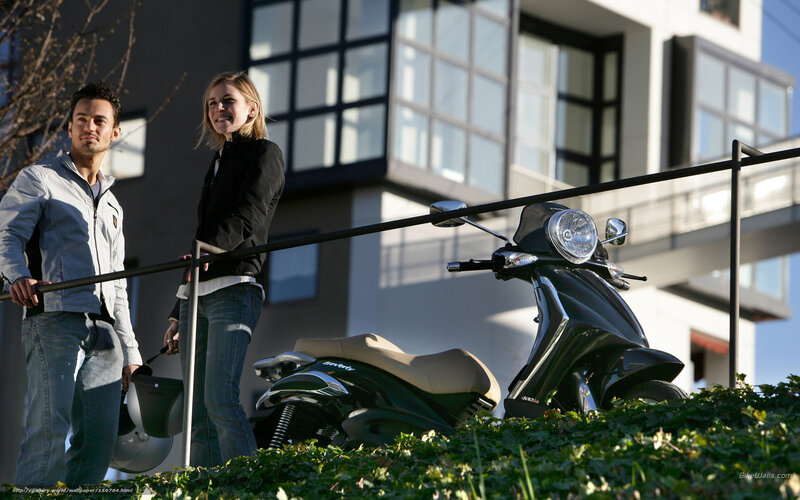 Couple with scooter in city