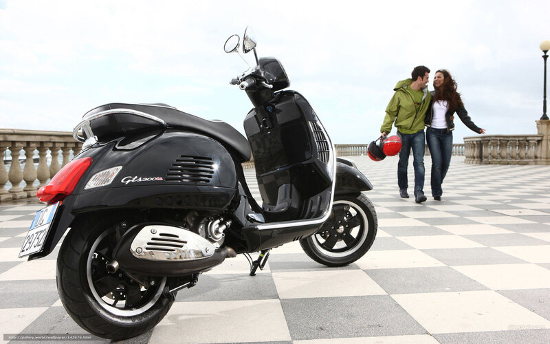 Couple with scooter on promenade