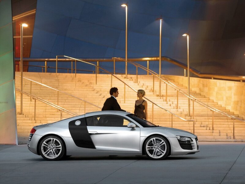 Couple with silver sports car
