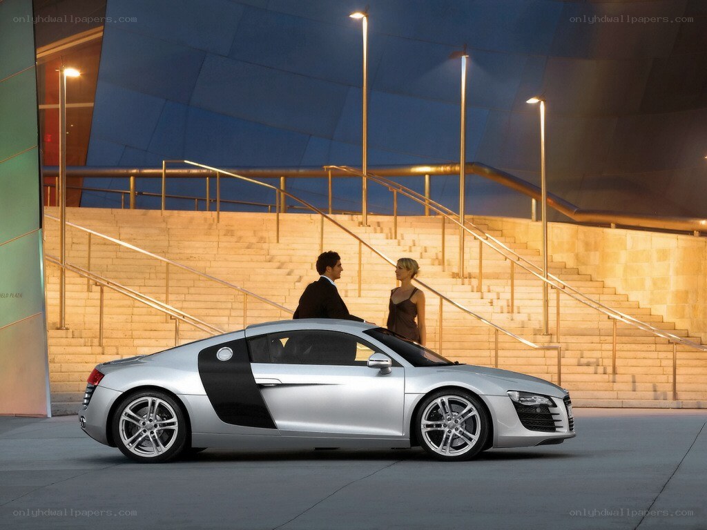 Couple with silver sports car