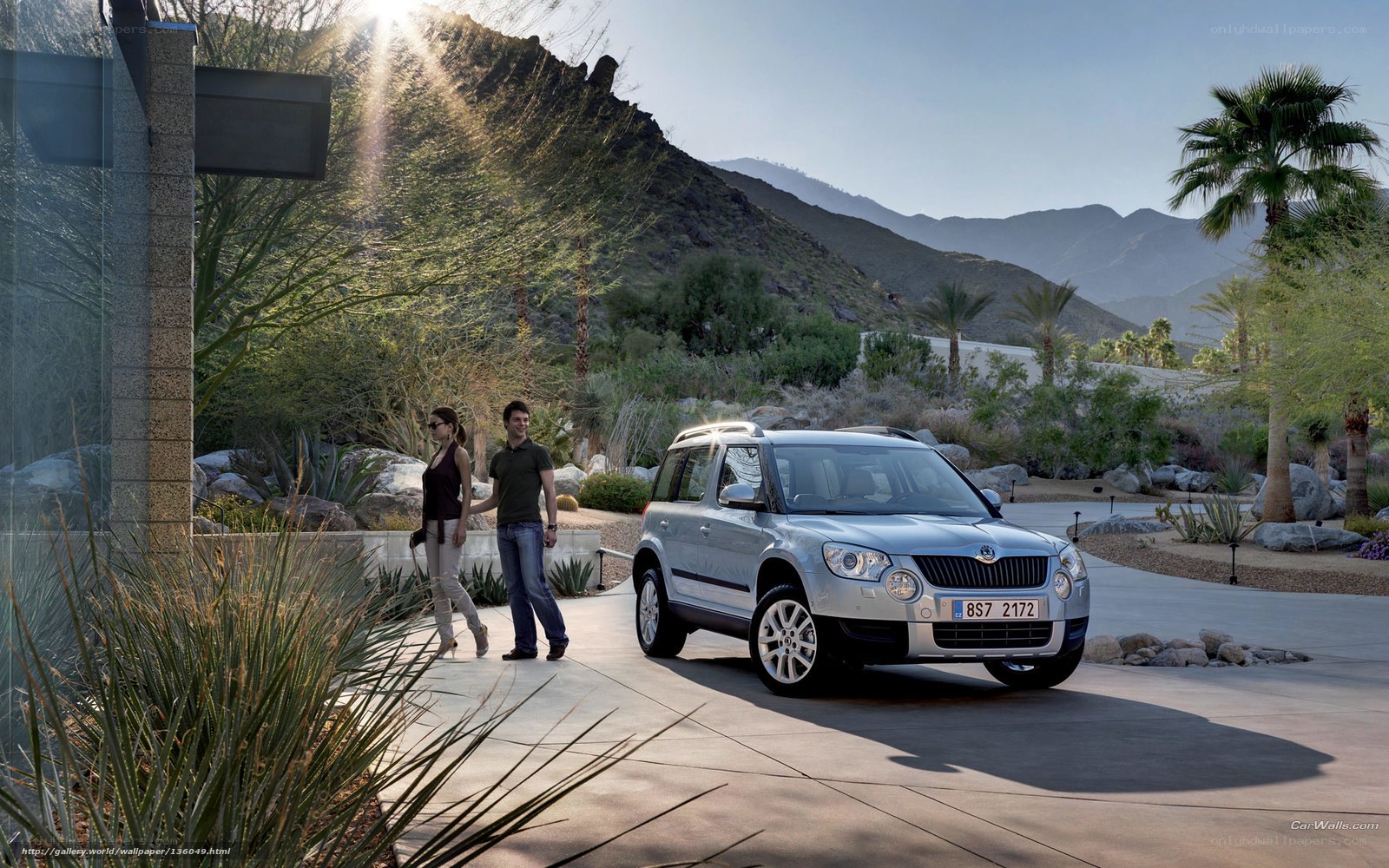 Couple with SUV in desert landscape