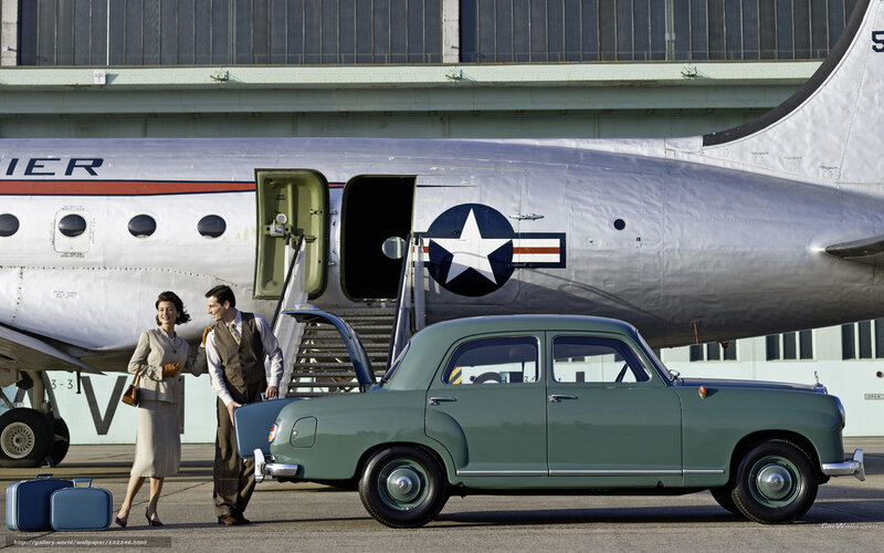 Couple with vintage car and airplane