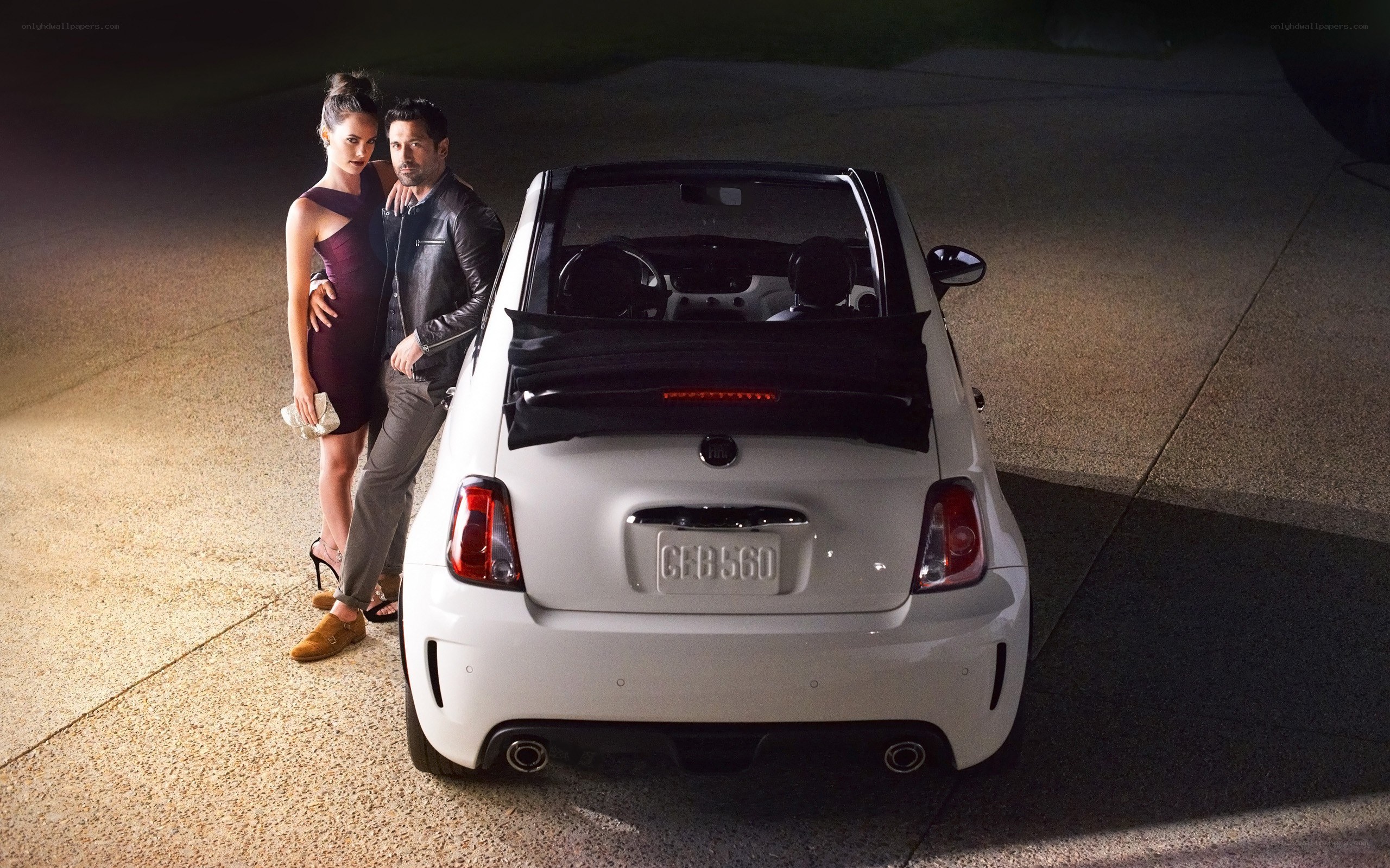 Couple with white convertible car