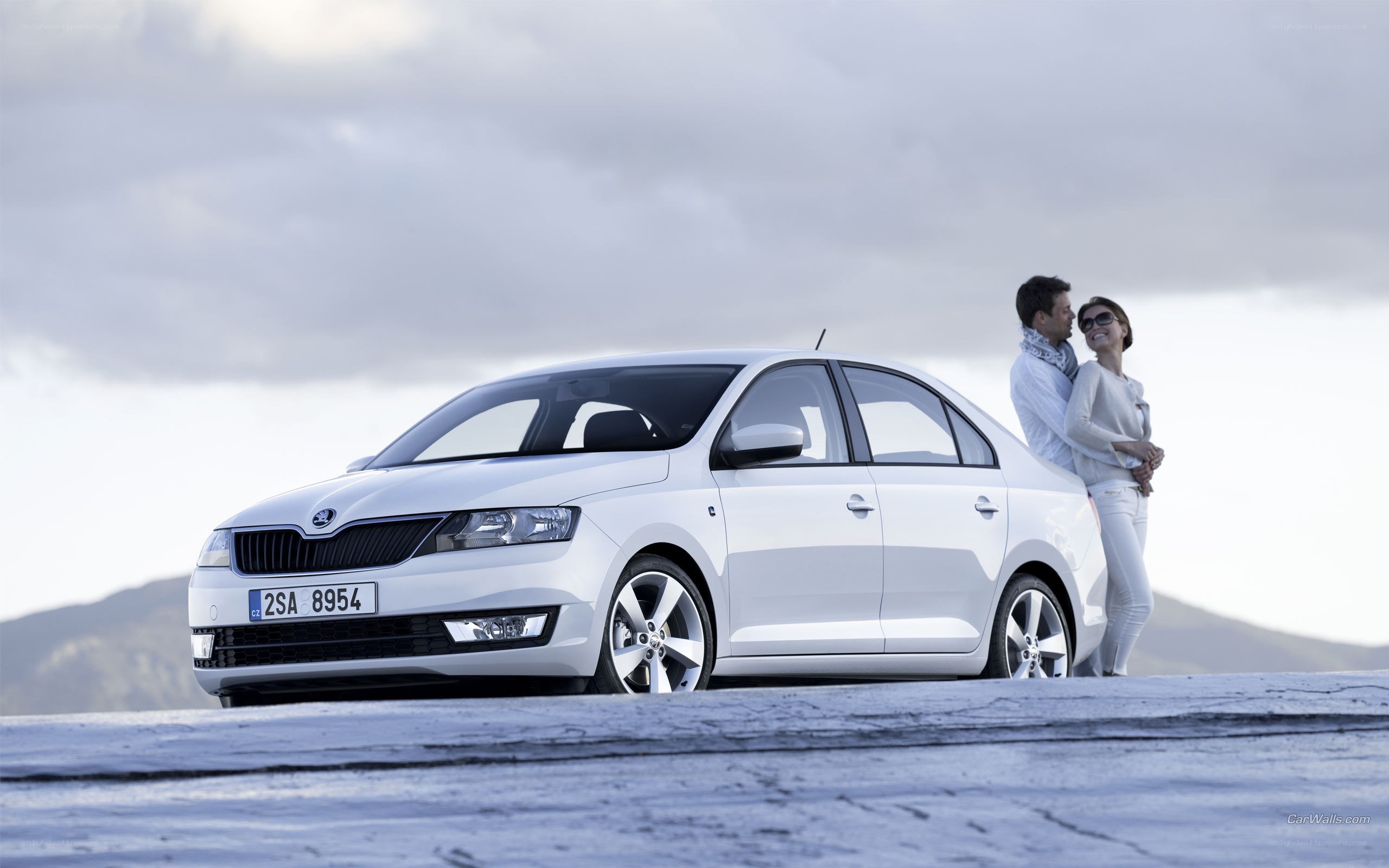 Couple with white sedan car