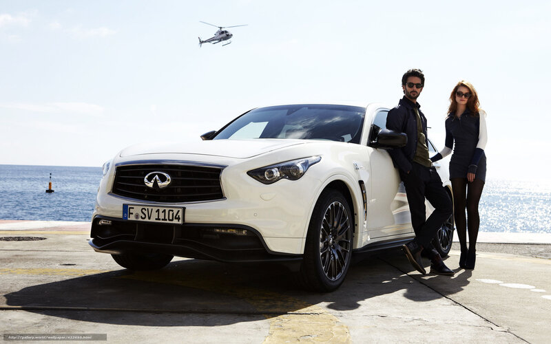 Couple with white SUV by the sea