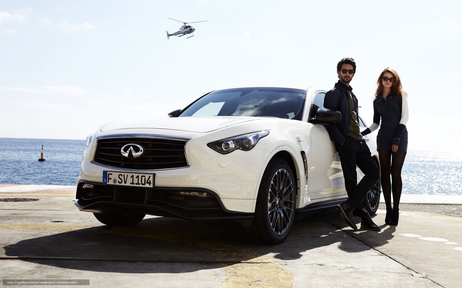 Couple with white SUV by the sea