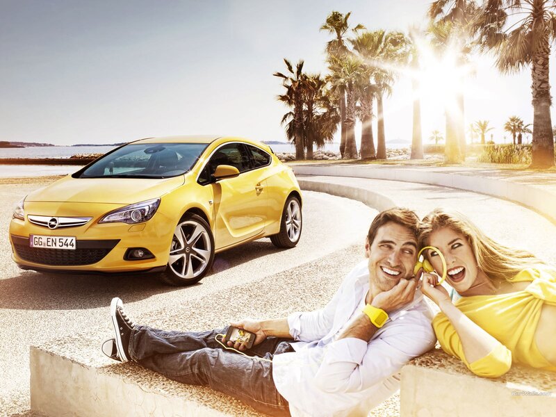 Couple with yellow car by the sea