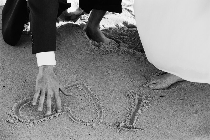 Couple writing in the sand