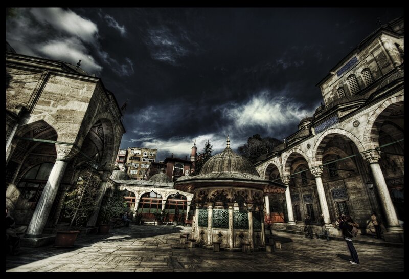 Courtyard with fountain under stormy sky