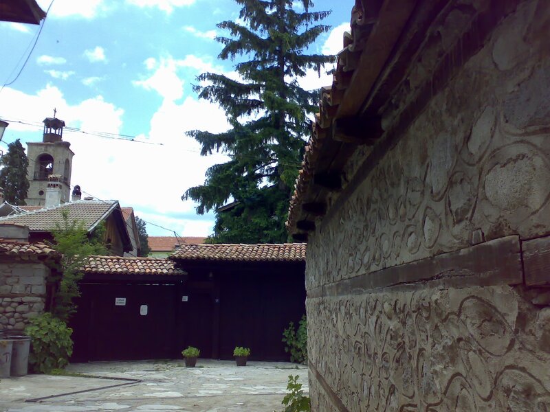 Courtyard with stone walls and church tower
