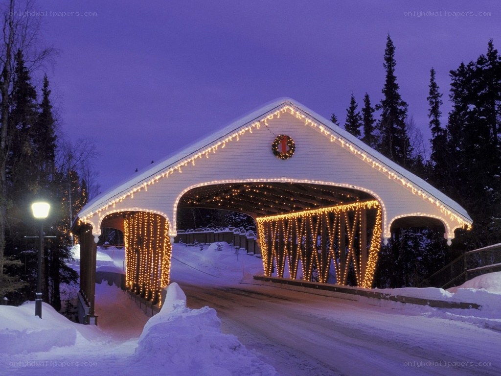 covered bridge at night in snow