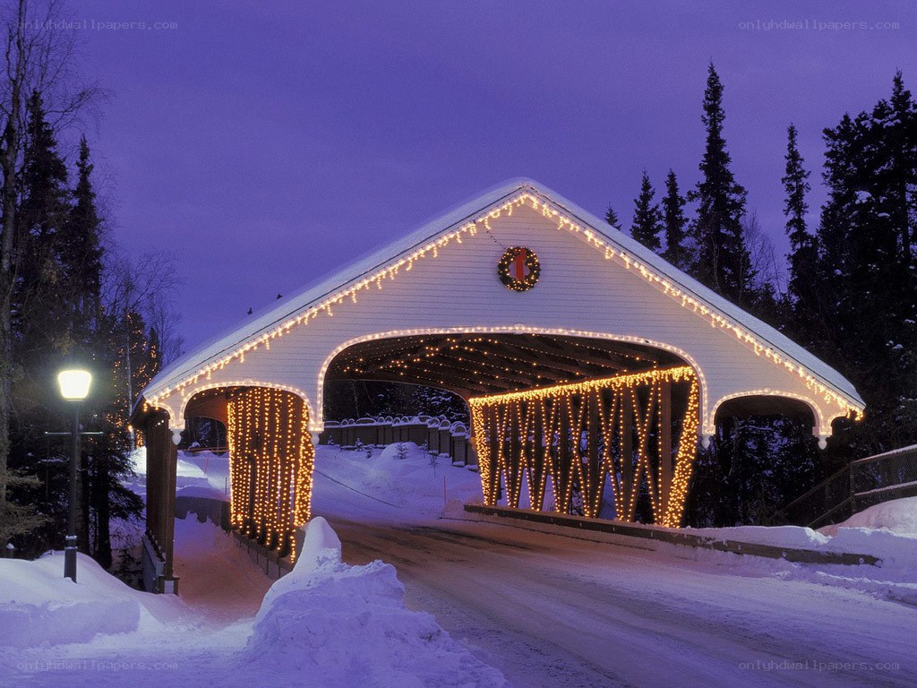 covered bridge at night in snow