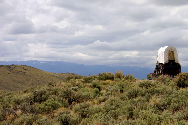 covered wagon on a hillside