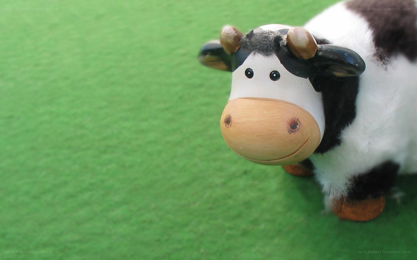 cow figurine on green surface
