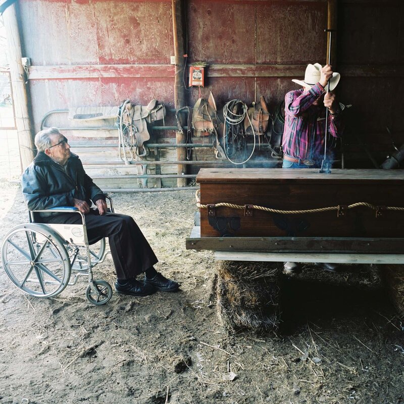 Cowboy and elder in a barn
