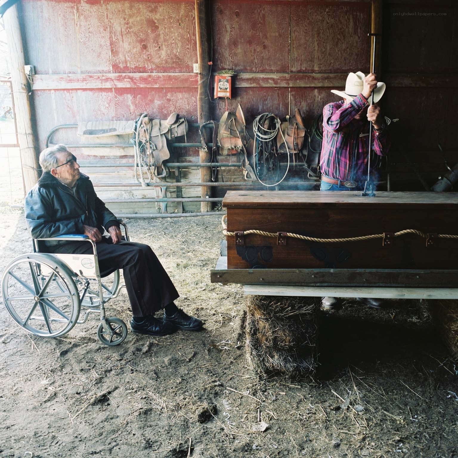 Cowboy and elder in a barn