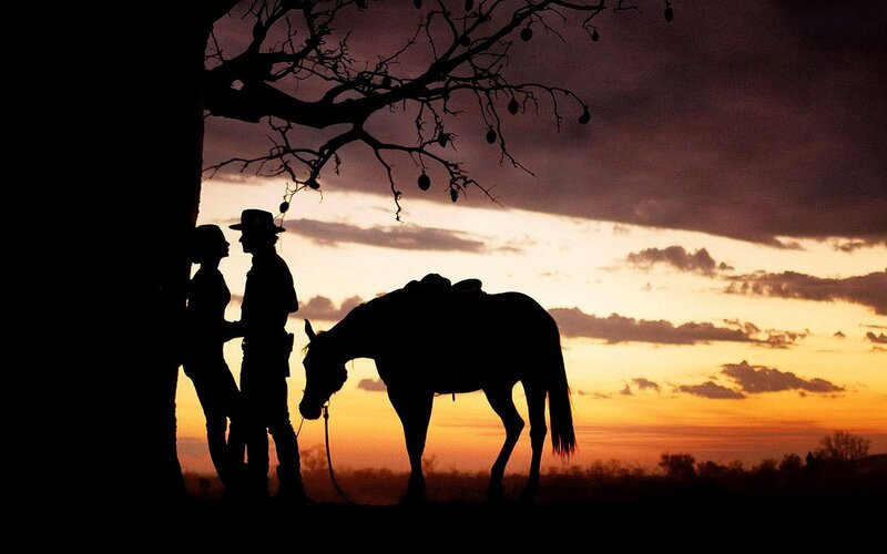 Cowboy and horse at sunset