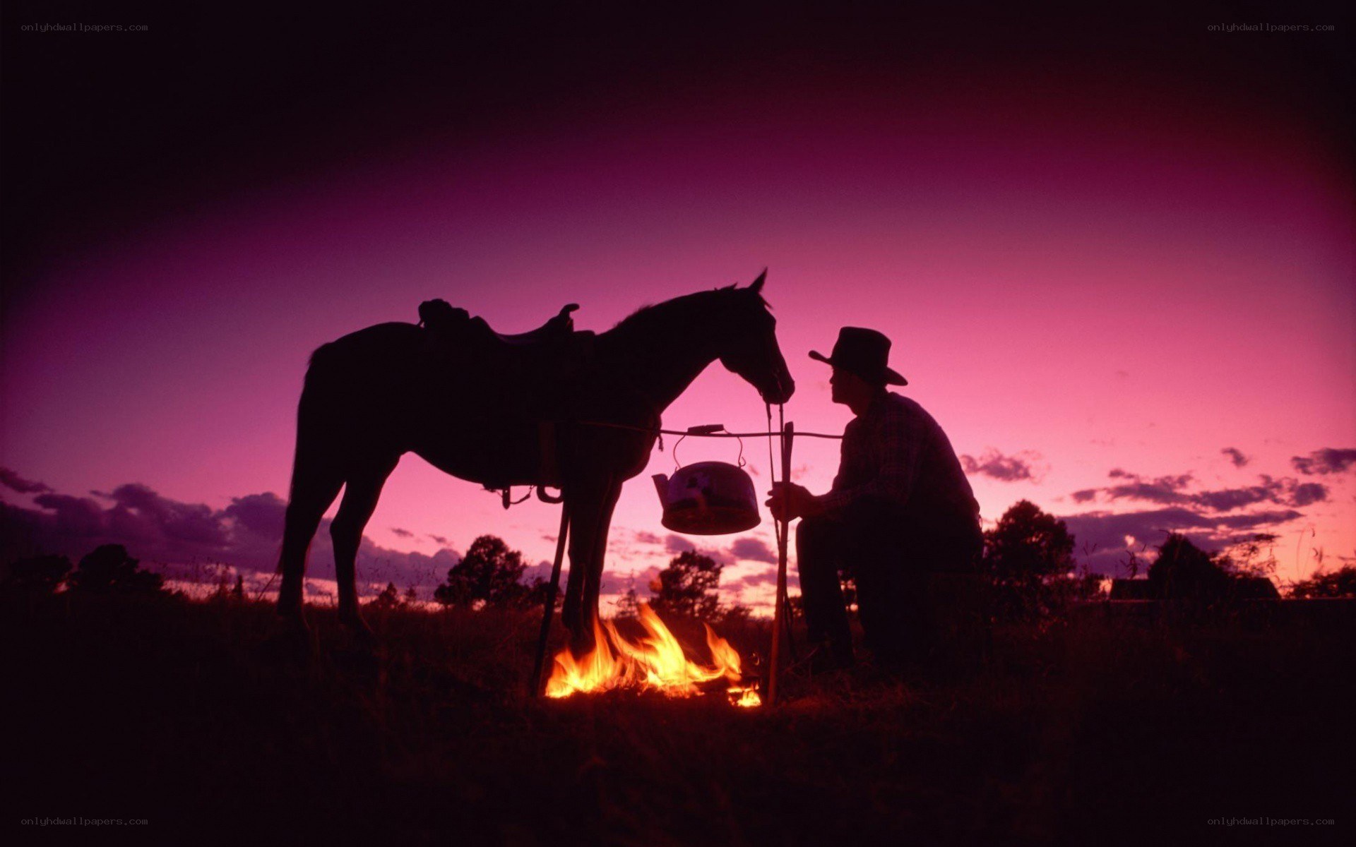 Cowboy by campfire at dusk