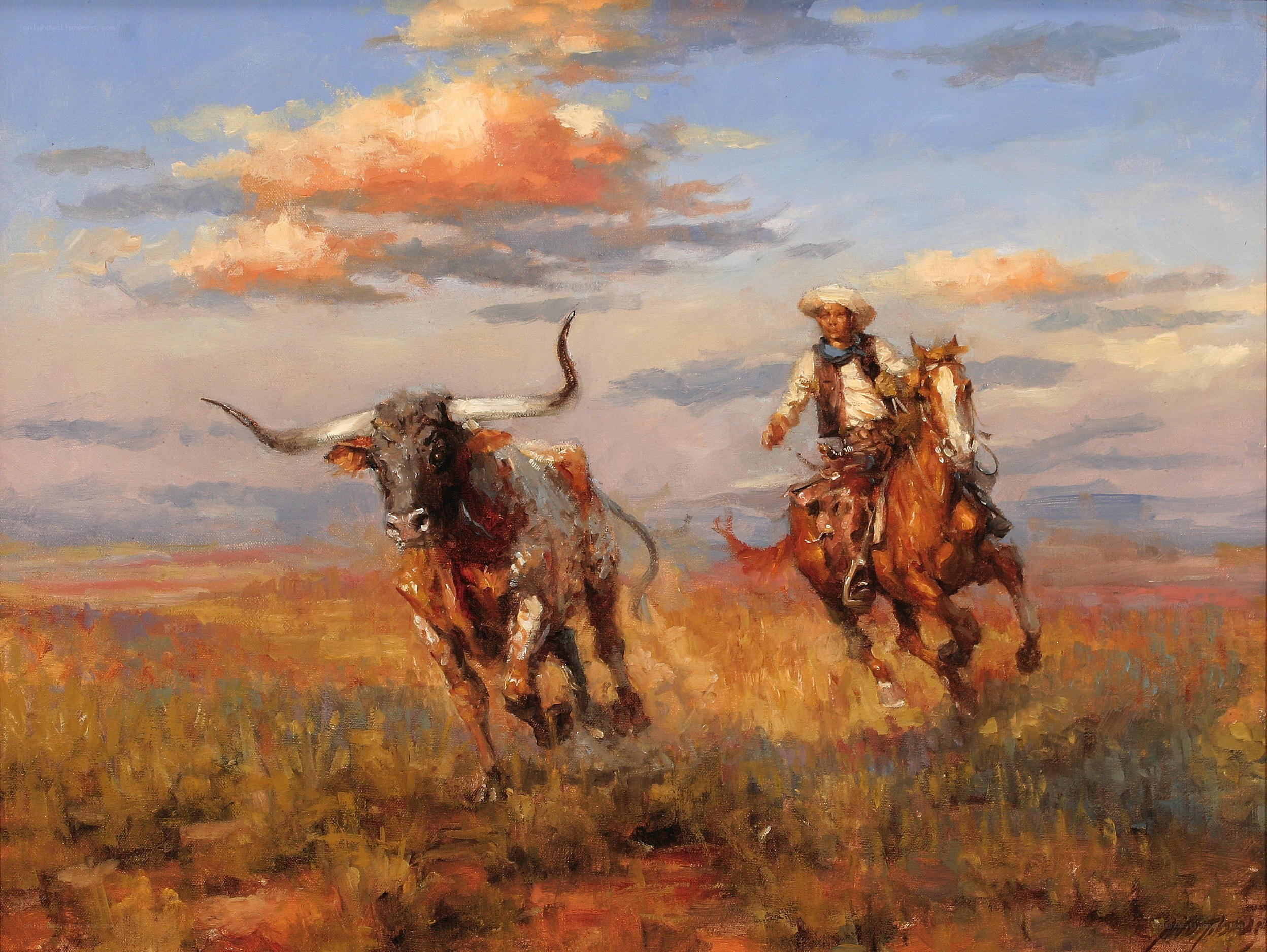 Cowboy chasing longhorn bull