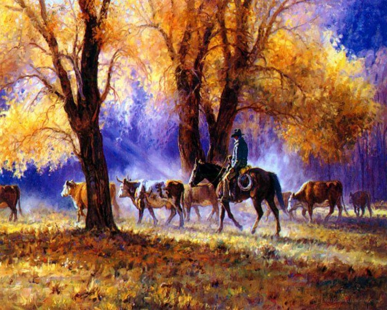 Cowboy herding cattle at dusk