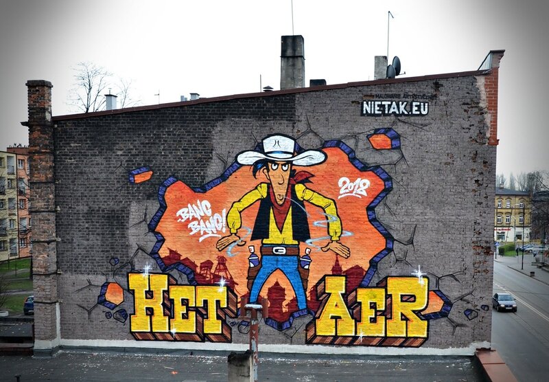 Cowboy mural on brick wall