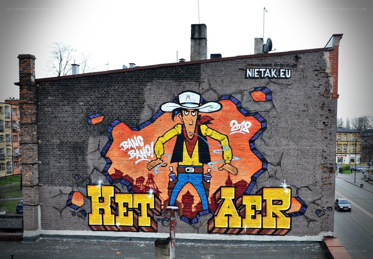 Cowboy mural on brick wall