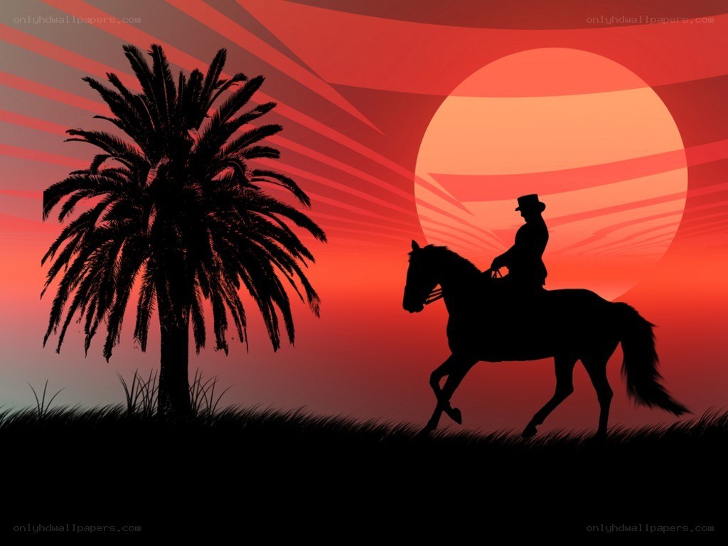 Cowboy on horse at sunset