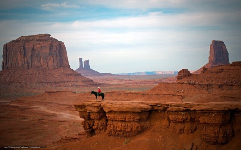 Cowboy on horse in desert