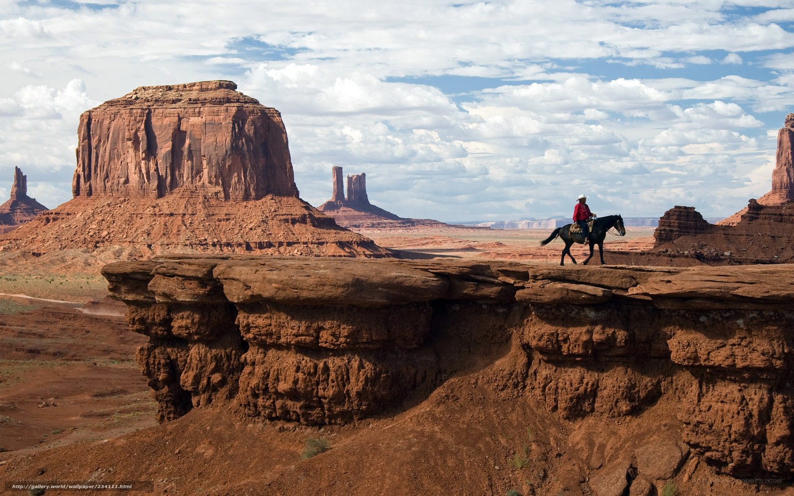 Cowboy on horseback in desert