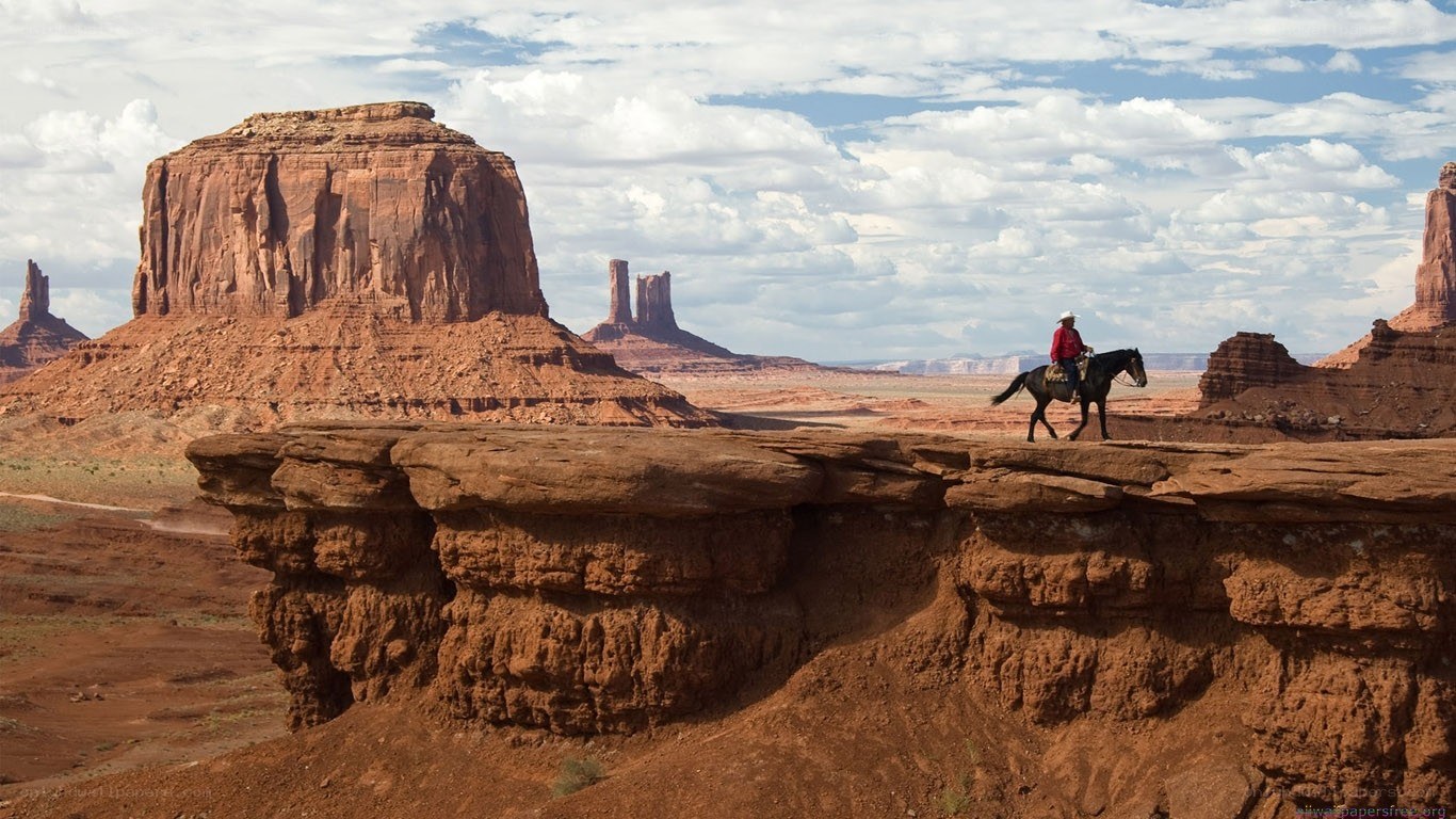Cowboy on horseback in desert