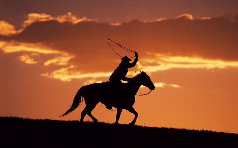 Cowboy on Horseback — Orange, Dramatic, Sunset