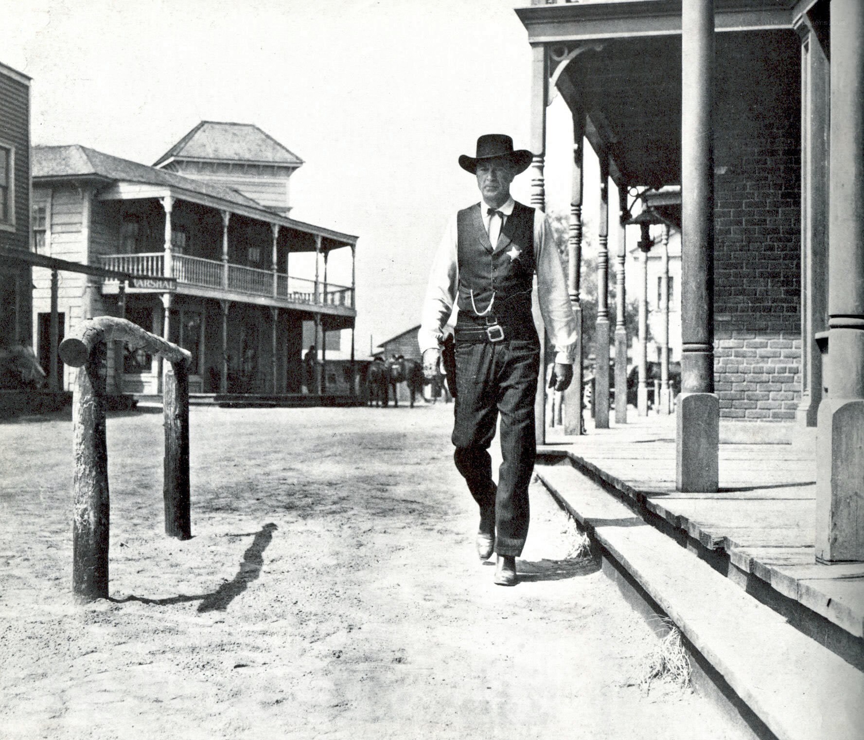 Cowboy walking down a dusty street