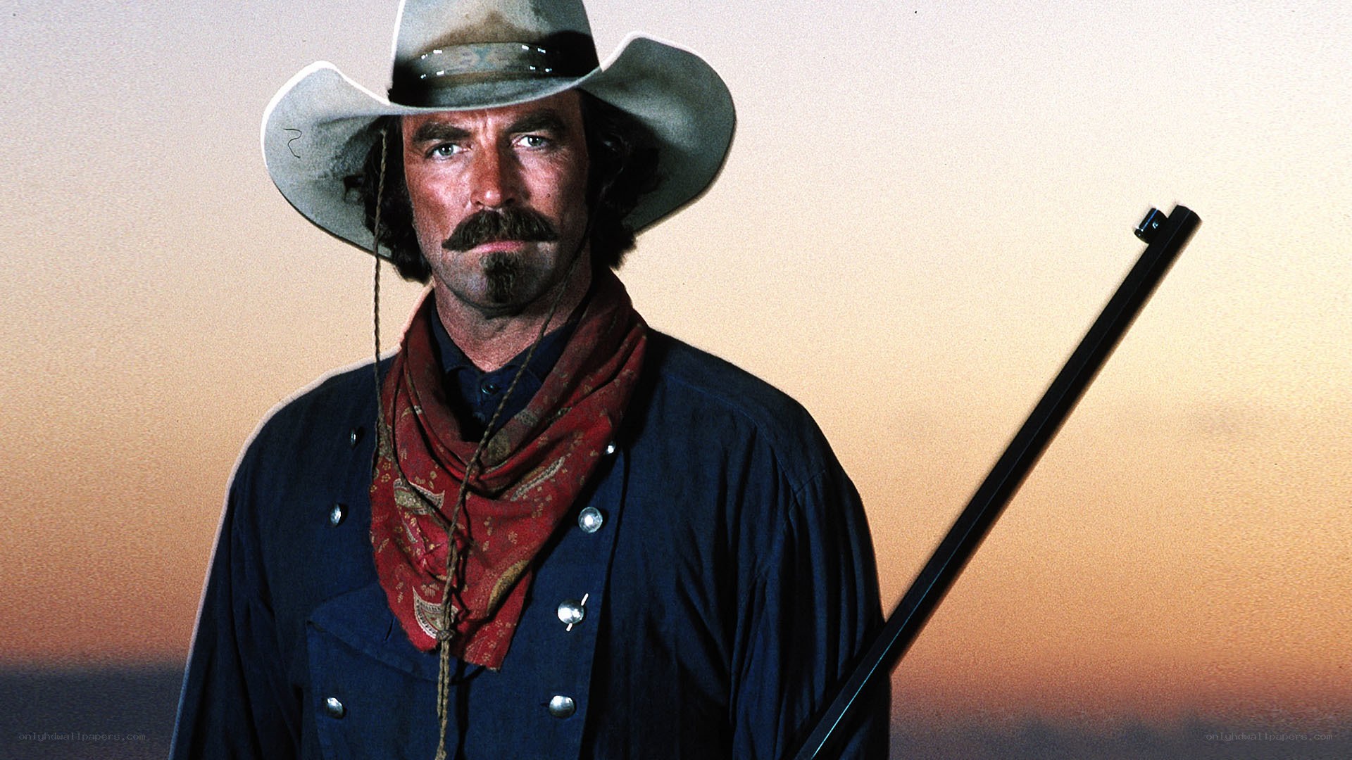 cowboy with rifle at sunset