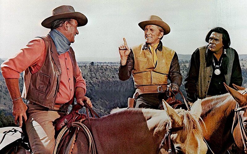 Cowboys on horseback in desert