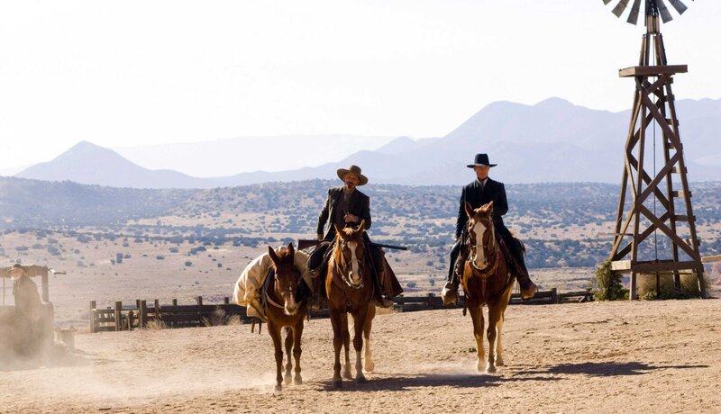 Cowboys on horseback in desert