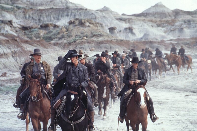 cowboys on horseback in desert