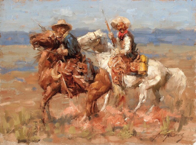 Cowboys on horseback in desert